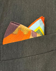 Colorful pocket square folded in a gray suit pocket